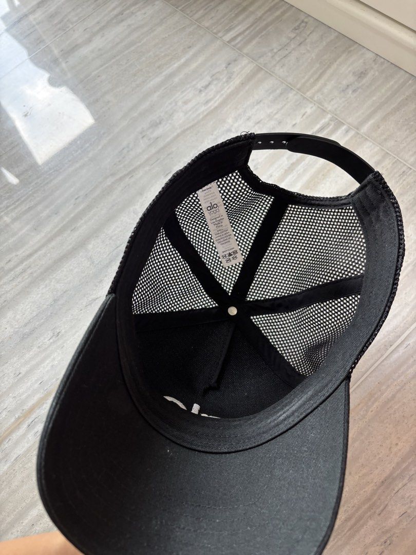 Authentic Alo Yoga Black Mesh Trucker Cap (Category: Hats & Beanies) located in Singapore. Submitted by silver.noblelion.82b488 (Listing ID 1443520639, Image 2). Description: Alo Yoga black trucker cap with breathable mesh back and adjustable strap. Features white embroidered logo. Cotton/polyester blend. Perfect for daily wear or workouts. Selling because I rarely use it. .