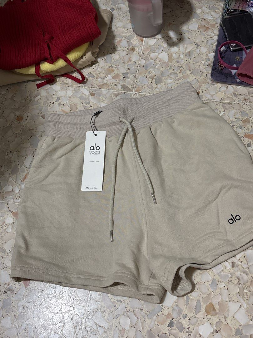 Alo Yoga Sweat Shorts Beige Drawstring Waist (Category: Activewear) located in Singapore. Submitted by huangsiqi414238 (Listing ID 1443679000, Image 2). Description: - Alo Yoga sweat shorts - Light beige color - Elastic waistband with drawstring - Two side pockets - Ideal for lounging and light workouts - Versatile wardrobe staple.
