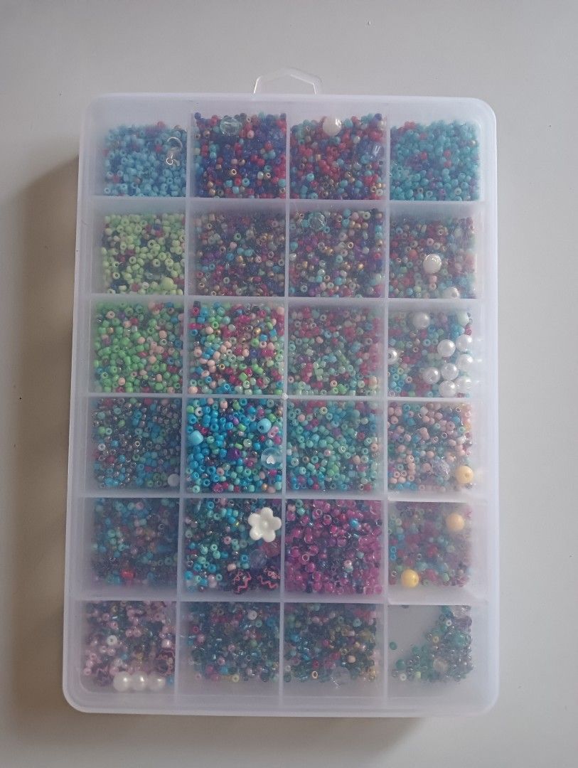 Assorted Craft Beads in Storage Box (Category: Craft Supplies & Tools) located in Porac. Submitted by redapple24 (Listing ID 1443498166, Image 1). Description: - Assorted beads in a clear organizer box - Includes tiny seed beads and pearl-like beads - Comes with a cute white flower charm - Ideal for jewelry making and DIY craft projects - Organizer box has 25 compartments, most are full.