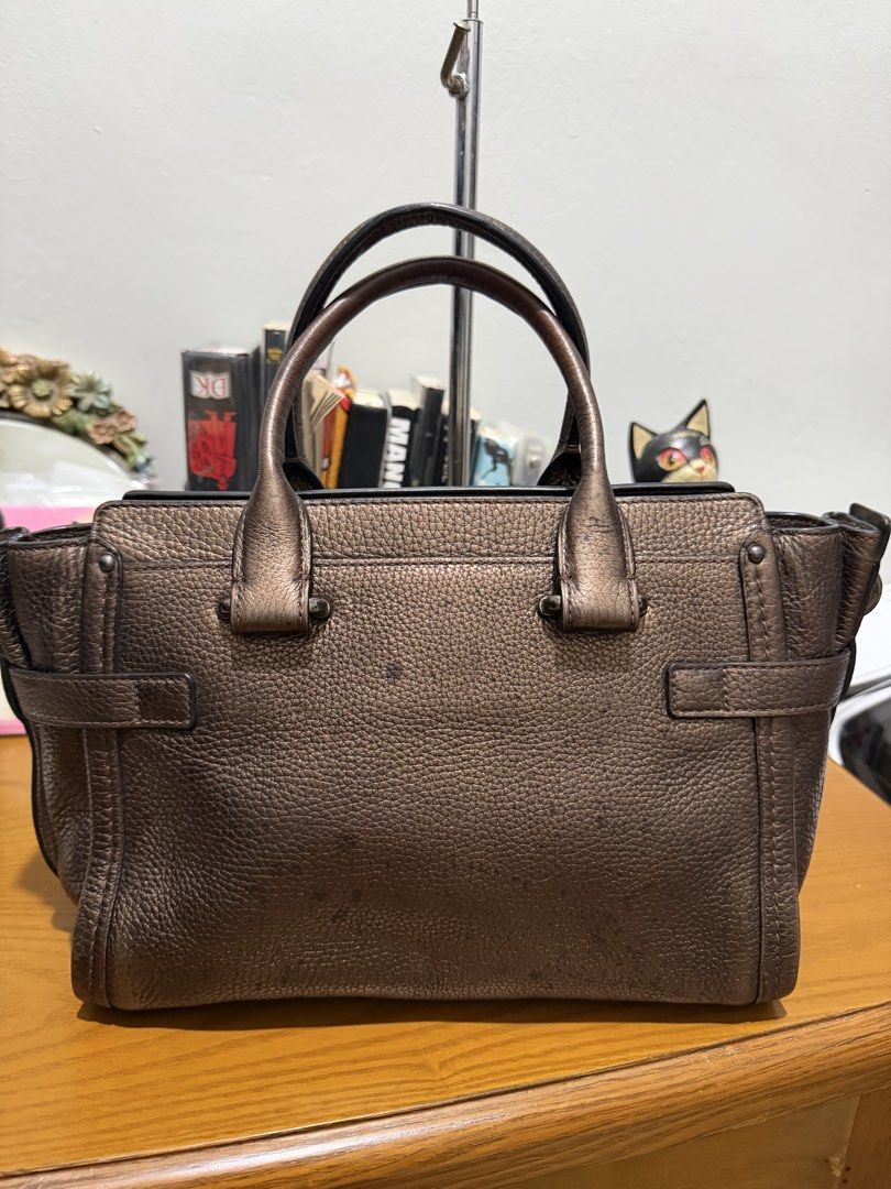 Authentic Coach Swagger 27 Metallic Bronze (Category: Luxury Bags & Wallets) located in General Santos City (Dadiangas). Submitted by prelovedpickers (Listing ID 1443662535, Image 2). Description: selling Authentic Coach Swagger 27 Metallic bronze missi sling and Hangtag With slight spot pebbled leather rate 10/10.