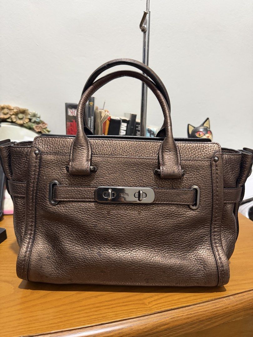 Authentic Coach Swagger 27 Metallic Bronze (Category: Luxury Bags & Wallets) located in General Santos City (Dadiangas). Submitted by prelovedpickers (Listing ID 1443662535, Image 1). Description: selling Authentic Coach Swagger 27 Metallic bronze missi sling and Hangtag With slight spot pebbled leather rate 10/10.