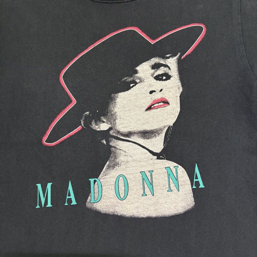 Black Madonna Graphic T-Shirt (Category: Tshirts & Polo Shirts ) located in Dapitan. Submitted by payt3es_thrift. (Listing ID 1443547992, Image 3). Description: - Black t-shirt with a graphic print of Madonna - Features Madonna's name below the image - Made in Korea - Ideal for any Madonna fan - Please check photos for detailed measurements.