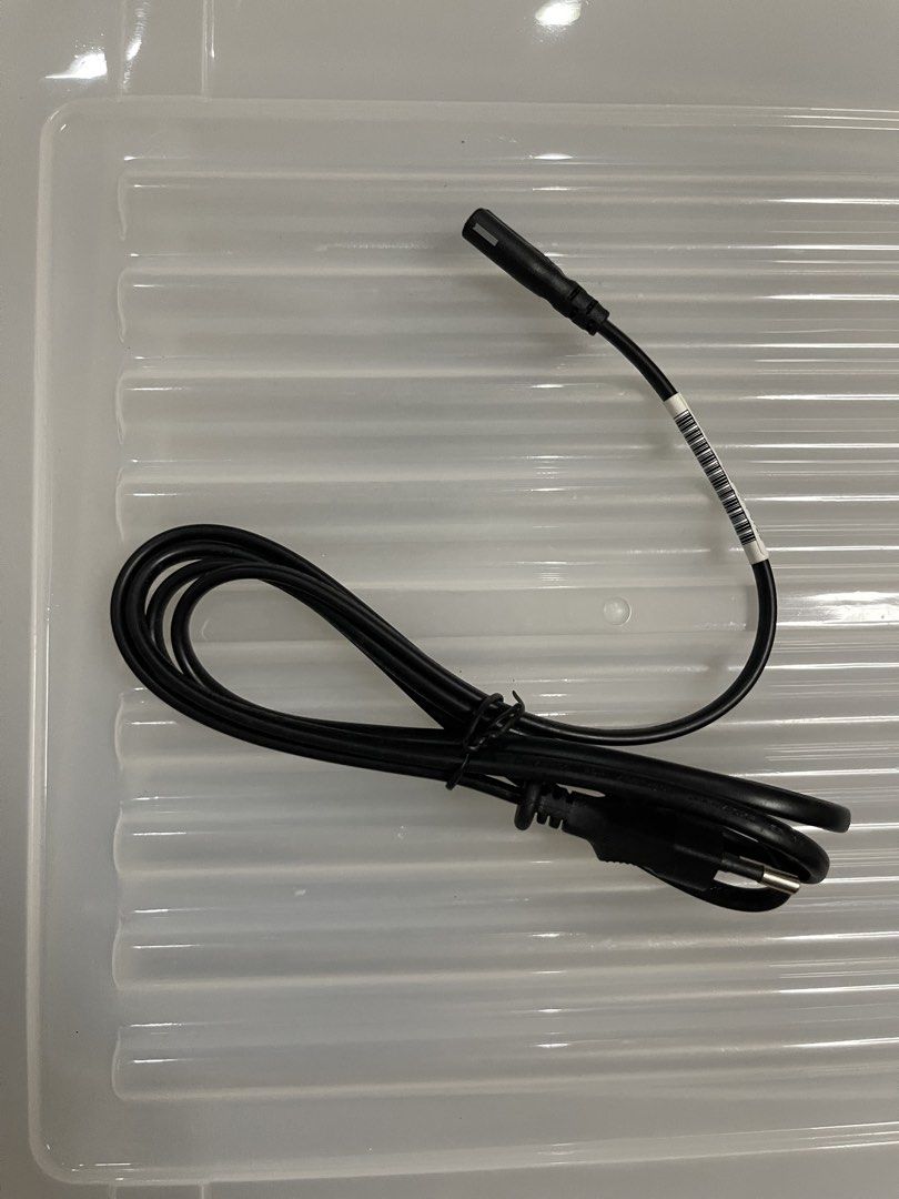 Black Power Cable with Connector (Category: Chargers & Cables) located in Quezon City. Submitted by jaedenry0228 (Listing ID 1443633683, Image 1). Description: - Black power cable - Approximately 1 meter in length - Features a standard connector on one end and a smaller connector on the other - Ideal for replacing lost or damaged power cables - Cable is neatly coiled with a barcode sticker.