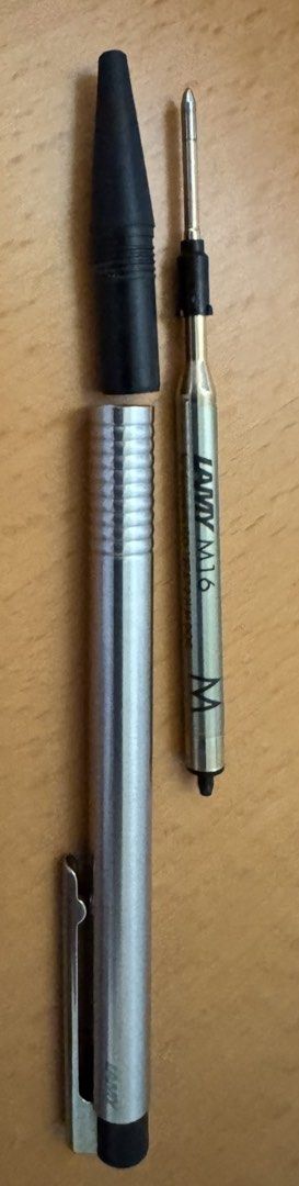 Bürkert-LAMY Ballpoint Pen with Lamy M16 Refill (Category: Stationery & School Supplies) located in Singapore. Submitted by cenedra (Listing ID 1443552636, Image 1). Description: - LAMY Silver metal pen body, black ballpoint - Features 'Bürkert' logo with a black cap - Includes Lamy M16 ballpoint refill (Medium point, marked 'M') - Free postage .