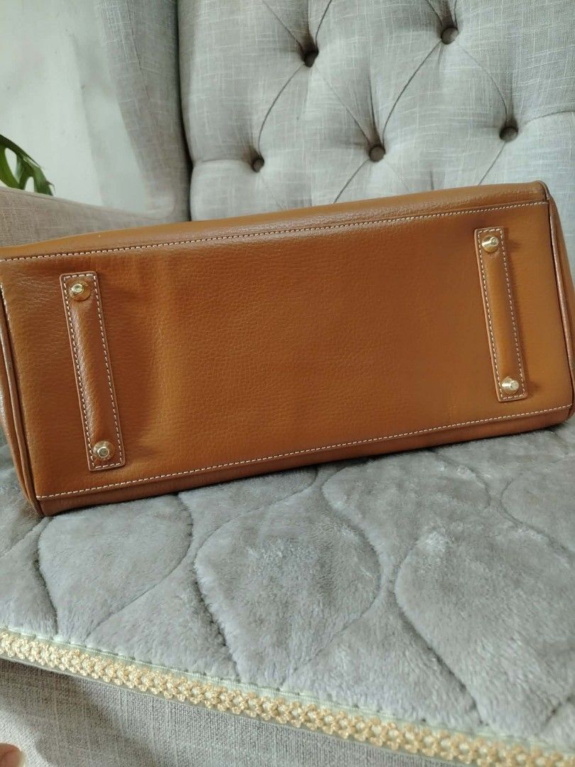 Brown Leather Handbag with Gold Hardware (Category: Luxury Bags & Wallets) located in Paranaque City. Submitted by yensfashionfinds (Listing ID 1443547235, Image 2). Description: - Classic brown leather handbag - Elegant gold hardware - Secure clasp closure - Multiple interior compartments for organization - Sturdy and comfortable handles - Timeless design for any occasion - Minor signs of wear on corners and edges, hence selling at a low price.
