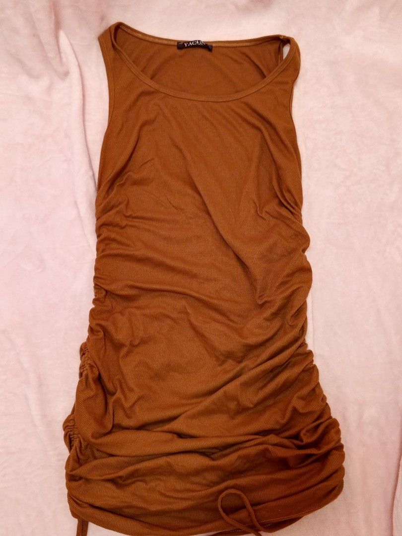 Brown Ruched Sleeveless Mini Dress (Category: Dresses) located in Manila. Submitted by aly_chy (Listing ID 1443549920, Image 1). Description: - Chic brown ruched mini dress - Sleeveless with a flattering scoop neck - Adjustable side drawstring for customizable ruching - Comfortable ribbed fabric - Versatile for night outs or casual wear - M-L.