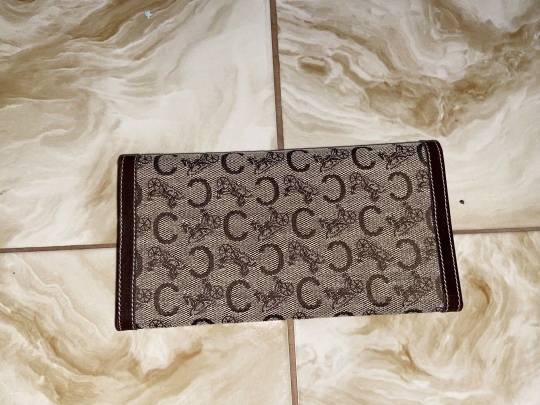 Celine Monogram Canvas Leather Tri-fold Wallet (Category: Luxury Bags & Wallets) located in Aroroy. Submitted by mahinaanlangs (Listing ID 1443507598, Image 2). Description: - Classic Celine tri-fold wallet - Iconic 'C' monogram canvas with brown leather trim - Multiple card slots and compartments - Secure snap closure - Made in Italy - Timeless essential Excellent condition 1K+Sf.