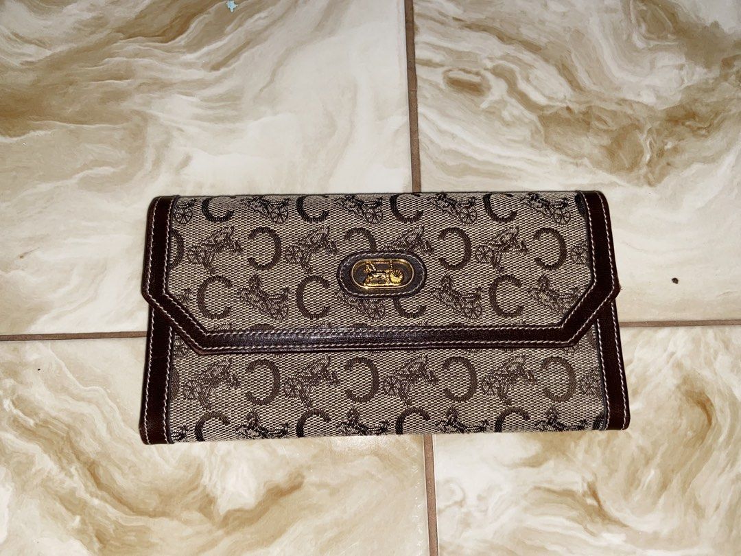 Celine Monogram Canvas Leather Tri-fold Wallet (Category: Luxury Bags & Wallets) located in Aroroy. Submitted by mahinaanlangs (Listing ID 1443507598, Image 1). Description: - Classic Celine tri-fold wallet - Iconic 'C' monogram canvas with brown leather trim - Multiple card slots and compartments - Secure snap closure - Made in Italy - Timeless essential Excellent condition 1K+Sf.