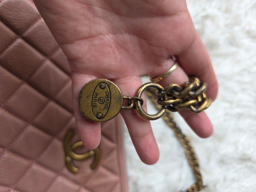 Chanel Pink Quilted Leather Chain Bag (Category: Luxury Bags & Wallets) located in Lemery. Submitted by venus23 (Listing ID 1443653148, Image 2). Description: - Chanel bag - Lovely pink hue - Classic quilted leather design - Gold-tone hardware - Chain strap with nice weight - Includes small charm with 'Chanel Paris' engraving - Ideal for nights out or adding a pop of color.