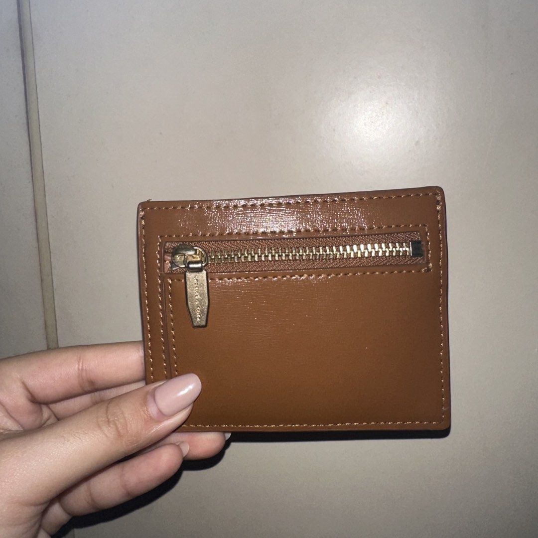 Charles & Keith Brown Card Holder with Zipper (Category: Wallets & Card holders) located in Quezon City. Submitted by getneedohdmnl (Listing ID 1443695298, Image 2). Description: Charles & Keith brown card holder with multiple card slots and a zippered compartment. DETAILS: - bought in BGC physical store - only flaw is the gold hardware: logo and zipper has signs of use already (faded a little) - card holder itself has no damages,, still looks br