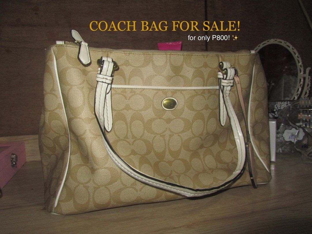 Coach Monogram Canvas Tote Bag (Category: Luxury Bags & Wallets) located in Cainta. Submitted by lovedleafs (Listing ID 1443612545, Image 1). Description: - Authentic Coach monogram canvas tote bag - Color: Beige with white trim and straps - Exterior pockets: 1 front open, 1 back open - Interior pockets: 1 zipper pocket, 1 additional zipper pocket, 2 small open pockets - Condition: Handle shows slight peeling/flaking - Origin: Made in Vietnam (as