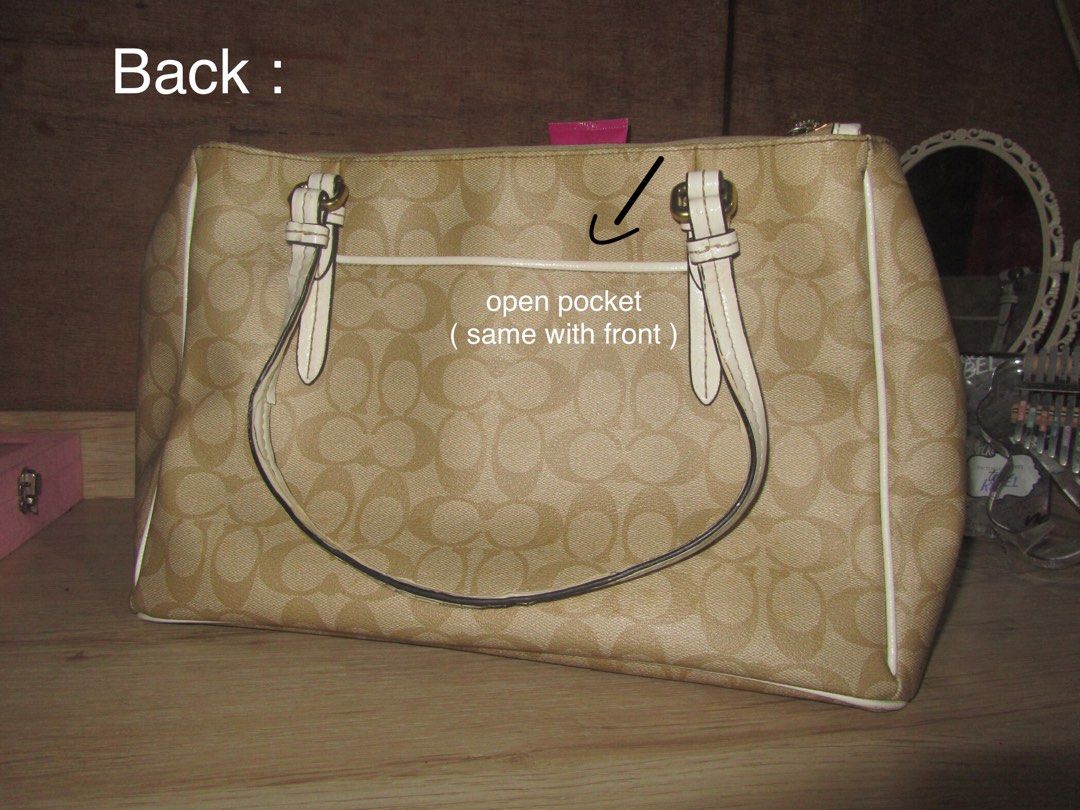Coach Monogram Canvas Tote Bag (Category: Luxury Bags & Wallets) located in Cainta. Submitted by lovedleafs (Listing ID 1443612545, Image 3). Description: - Authentic Coach monogram canvas tote bag - Color: Beige with white trim and straps - Exterior pockets: 1 front open, 1 back open - Interior pockets: 1 zipper pocket, 1 additional zipper pocket, 2 small open pockets - Condition: Handle shows slight peeling/flaking - Origin: Made in Vietnam (as