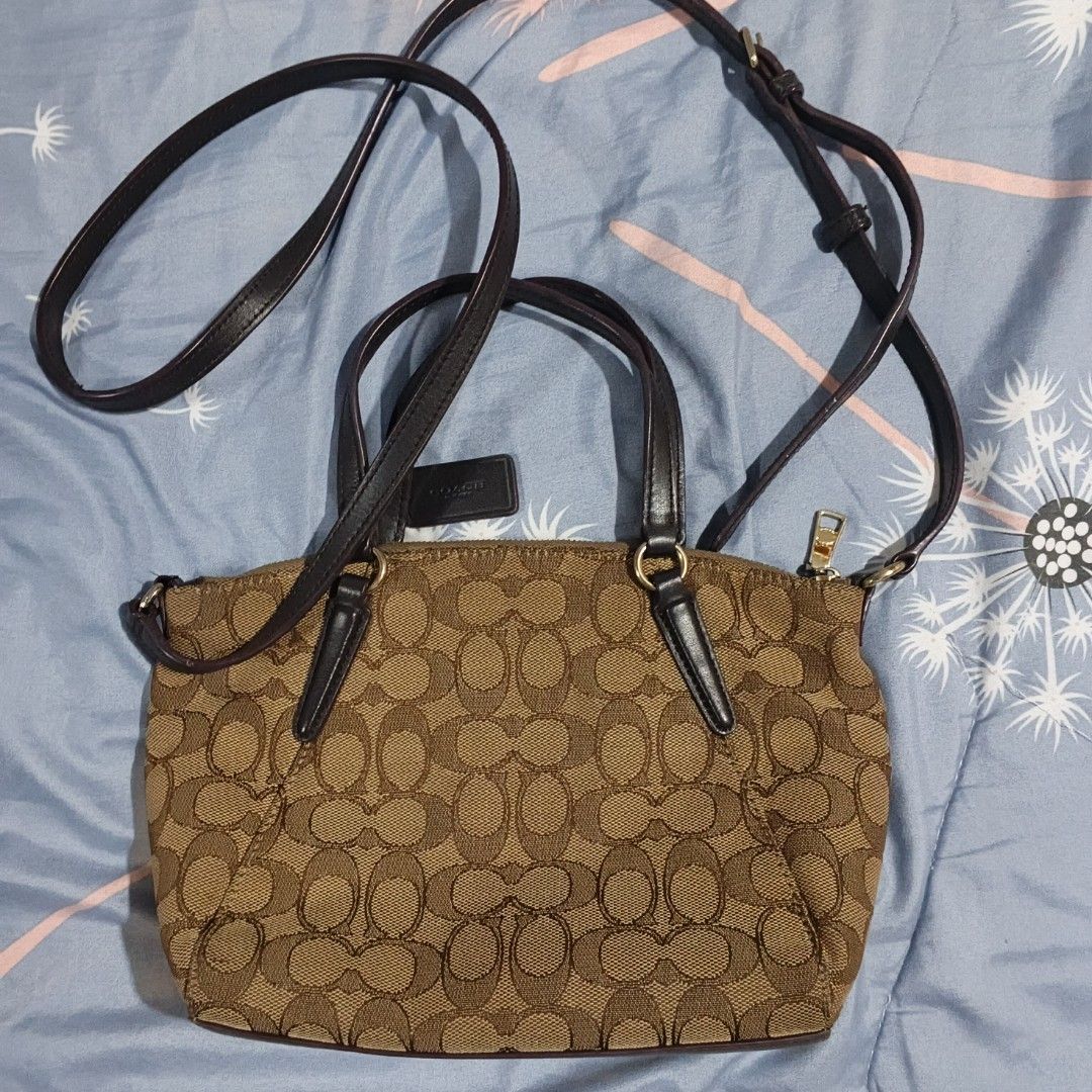 Coach Signature Monogram Canvas Satchel Bag (Category: Cross-body Bags) located in Carmona. Submitted by genkrist (Listing ID 1443553430, Image 3). Description: - Authentic brown Coach monogram canvas satchel - Features stylish leather trim and handles - Includes an adjustable crossbody strap for versatile wear - Secure zipper closure to keep your belongings safe - Interior tag confirms 'made in vietnam' - An ideal and practical bag for everyday 