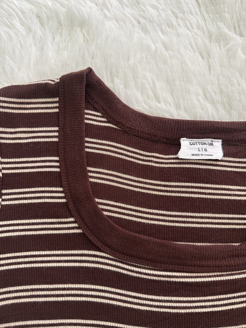 Cotton On Striped Cropped T-shirt (Category: Shirts) located in Apalit. Submitted by preloved_by_j. (Listing ID 1443552259, Image 2). Description: - Brand: Cotton On - Style: Cropped T-shirt - Color: Brown and white stripes - Neckline: Square neck - Sleeves: Short sleeves - Material: Ribbed - Occasion: Casual wear.