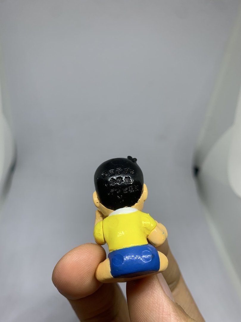 Doraemon Nobita Nobi Figure Toy (Category: Figurines & Statues) located in Caloocan City. Submitted by ekivilleg86508 (Listing ID 1443553346, Image 3). Description: - Adorable Nobita Nobi figurine - Iconic yellow shirt and blue shorts outfit - Features text detail on the back of the head - Perfect collectible for any Doraemon enthusiast - Ideal for display and showcasing your fandom.