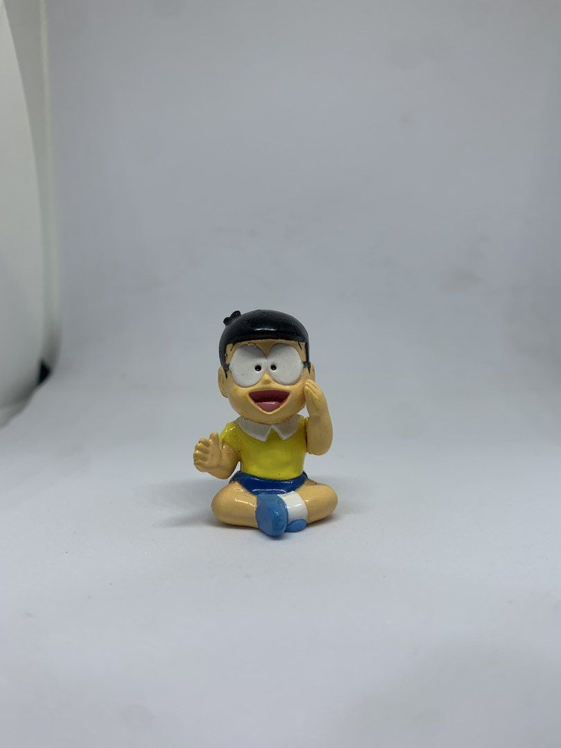 Doraemon Nobita Nobi Figure Toy (Category: Figurines & Statues) located in Caloocan City. Submitted by ekivilleg86508 (Listing ID 1443553346, Image 1). Description: - Adorable Nobita Nobi figurine - Iconic yellow shirt and blue shorts outfit - Features text detail on the back of the head - Perfect collectible for any Doraemon enthusiast - Ideal for display and showcasing your fandom.