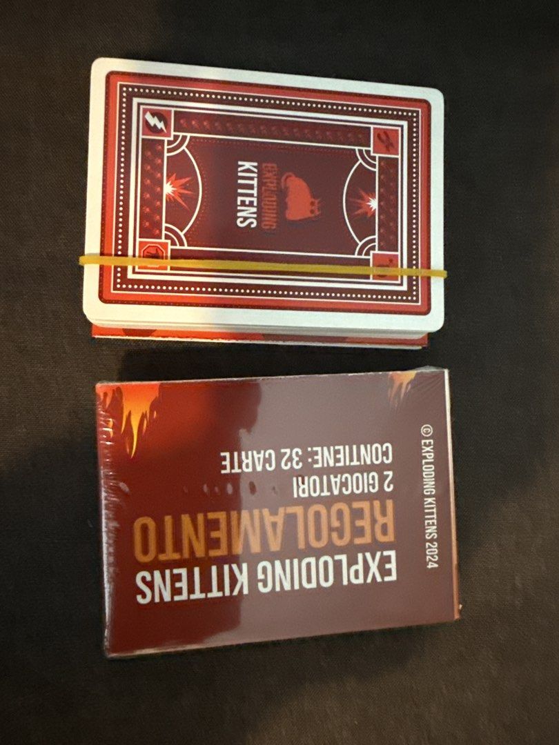 Exploding Kittens Card Game (Italian version) (Category: Board Games & Puzzles) located in Singapore. Submitted by prettylittlewoopie (Listing ID 1443501913, Image 1). Description: 2 sets to let go. Both Italian version. One pack is opened, unused in brand new condition, other pack new in plastic Both for $6 , self collect or top up for mailing - Exploding Kittens Card Game - 2024 Edition - Brand new, still sealed in plastic - Suitable for 2 play