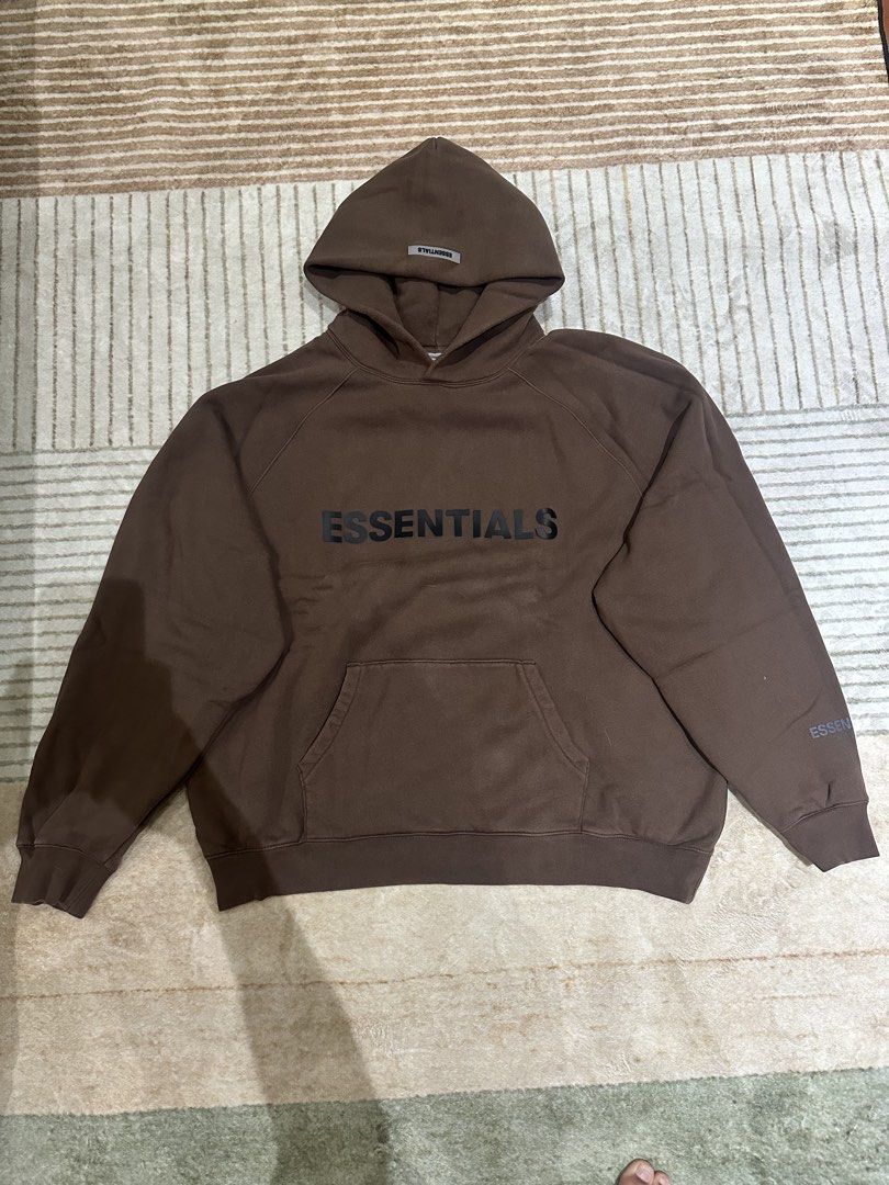 Fear of God Essentials Brown Hoodie XL (Category: Hoodies) located in Manila. Submitted by deveramaxi09722 (Listing ID 1443654747, Image 1). Description: - Brand: Fear of God Essentials - Color: Brown - Size: XL - Features: Classic Essentials logo on chest, smaller logo detail on sleeve - Origin: Made in Vietnam ISSUE IN LETTERS FALLING OFF.