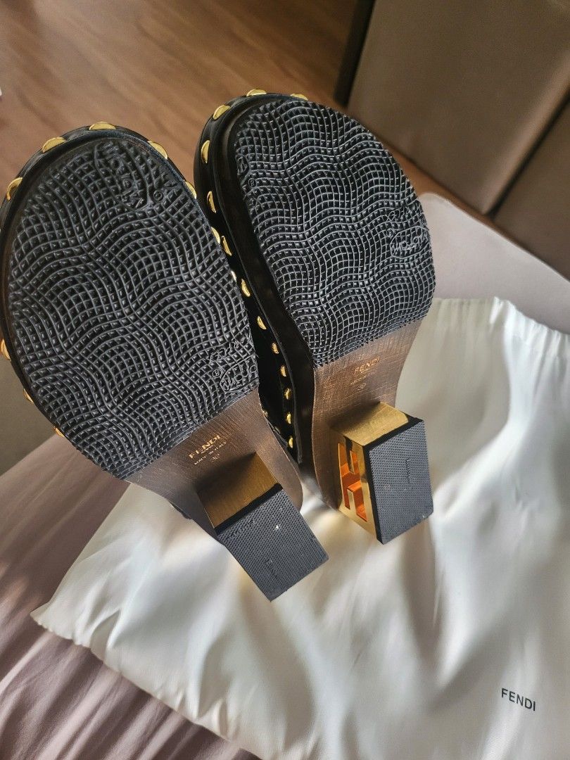 Fendi Black Leather Clogs with Gold Accents (Category: Sneakers & Footwear) located in Manila. Submitted by jml.ecg (Listing ID 1443512151, Image 3). Description: - Fendi black leather clogs - Gold stud details around the sole - Wooden heel with gold accent - Comes with Fendi dust bag - Ideal for a stylish slip-on option.