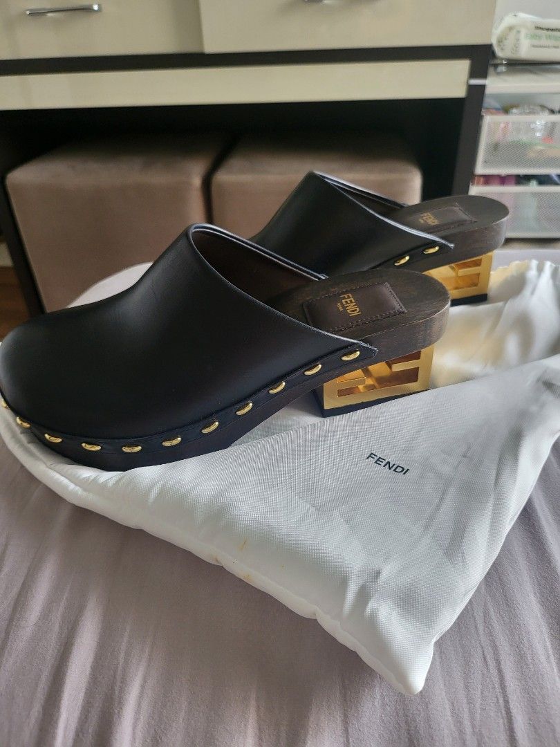 Fendi Black Leather Clogs with Gold Accents (Category: Sneakers & Footwear) located in Manila. Submitted by jml.ecg (Listing ID 1443512151, Image 2). Description: - Fendi black leather clogs - Gold stud details around the sole - Wooden heel with gold accent - Comes with Fendi dust bag - Ideal for a stylish slip-on option.