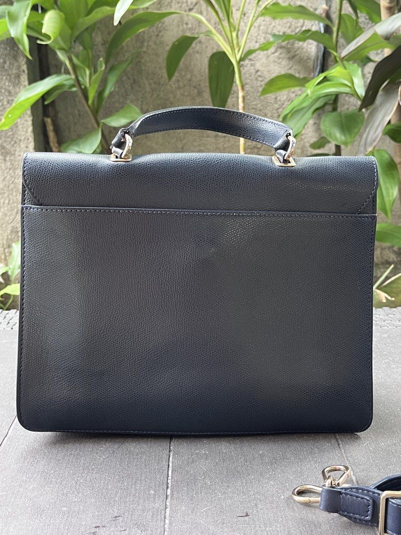 Furla Navy Leather Briefcase Bag with Shoulder Strap (Category: Luxury Bags & Wallets) located in Quezon City. Submitted by thriftfindsphqc (Listing ID 1443696651, Image 3). Description: - Navy blue leather briefcase style handbag - Secure turn-lock closure with elegant gold hardware - Includes a detachable shoulder strap for versatile carrying - Comfortable top handle - Textured leather finish for a sophisticated look - Ample interior space for 
