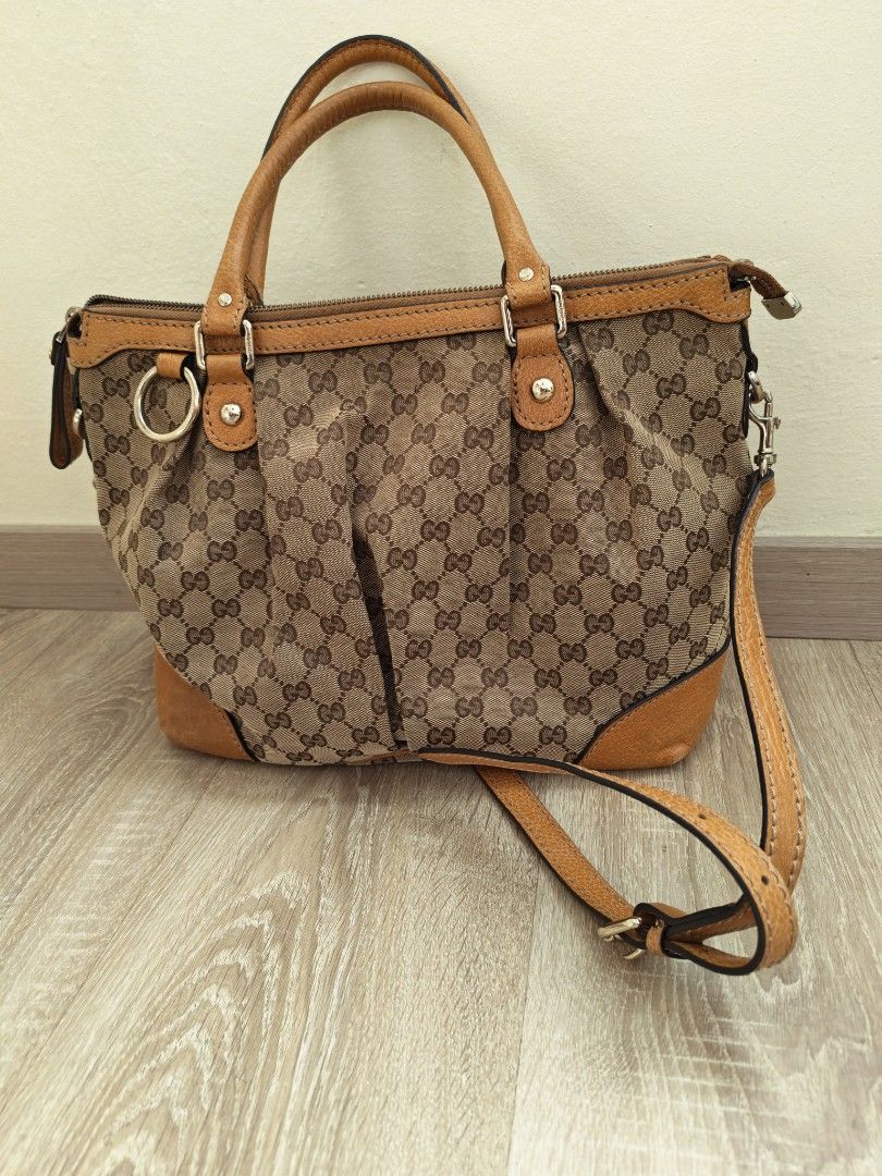 Gucci Monogram Canvas Leather Trimmed Handbag (Category: Bags & Wallets) located in Ampang. Submitted by uniquestuff68 (Listing ID 1443504896, Image 1). Description: -Fabric body and leather on the - brown parts together with long leather strap. - Condition :6/10 - COD Ampang/Cheras - Postage exclude .