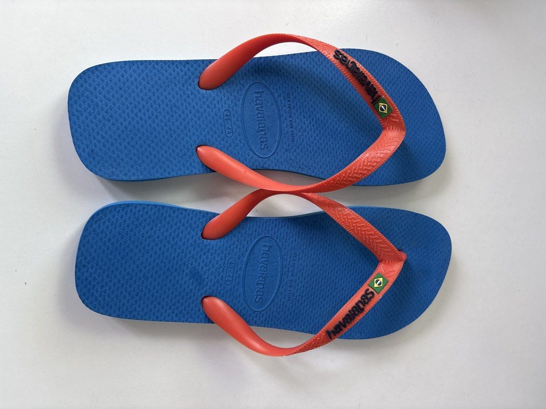 Havaianas Blue Flip-Flops with Coral Straps (Category: Flipflops and Slides) located in Singapore. Submitted by philippelh (Listing ID 1443534436, Image 1). Description: - Classic Havaianas flip-flops - Blue soles with bright coral straps - Havaianas logo and Brazilian flag detail on straps - Comfortable and casual for everyday wear - Ideal for beach or pool.