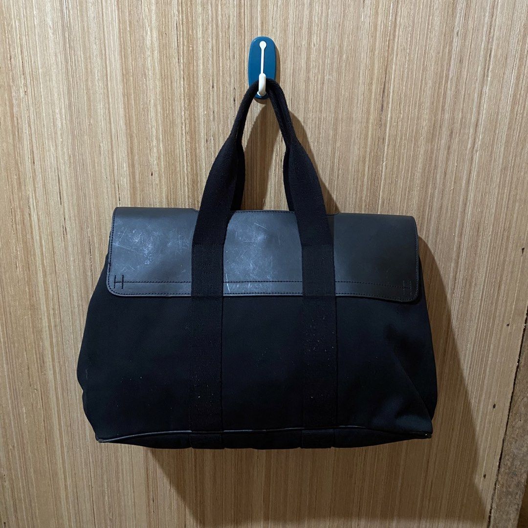 Hermes Black Canvas Leather Tote Bag (Category: Luxury Bags & Wallets) located in Dipolog. Submitted by thriftcher (Listing ID 1443600137, Image 2). Description: - Black canvas tote bag - Genuine leather accents - Iconic Hermes Paris snap button closure - Spacious interior, perfect for daily essentials or travel - Comfortable carrying handles - Minimalist and chic design - Some signs of wear on leather, consistent with normal use Pm.