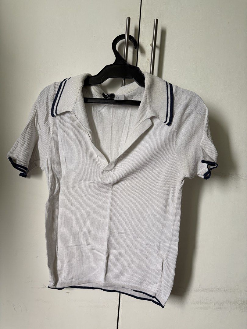 H&M Divided Ribbed Polo Shirt (Category: Shirts) located in Pasig City. Submitted by declutter_dpc (Listing ID 1443611767, Image 2). Description: - White ribbed polo shirt from H&M Divided - Short sleeves with navy trim - Collar also features navy trim - Ideal for casual wear.