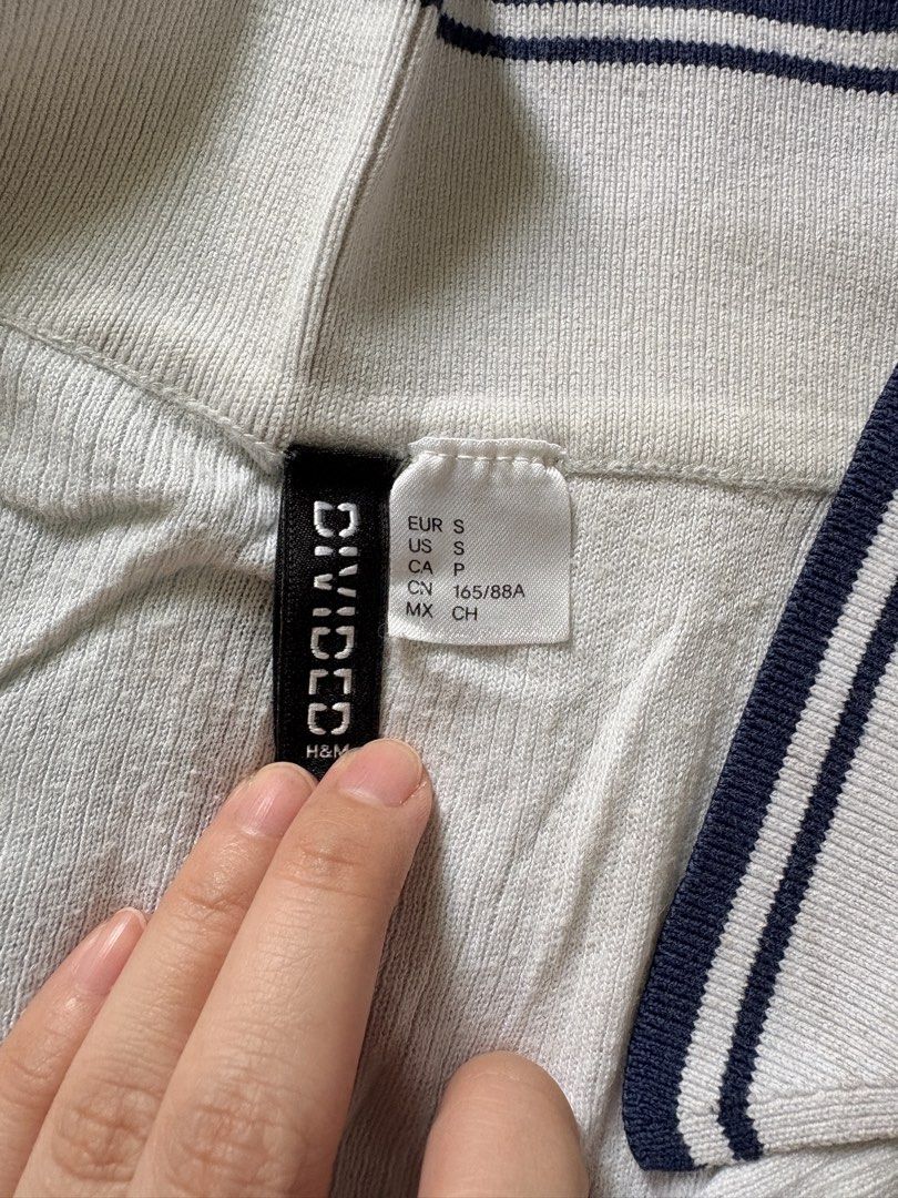 H&M Divided Ribbed Polo Shirt (Category: Shirts) located in Pasig City. Submitted by declutter_dpc (Listing ID 1443611767, Image 3). Description: - White ribbed polo shirt from H&M Divided - Short sleeves with navy trim - Collar also features navy trim - Ideal for casual wear.