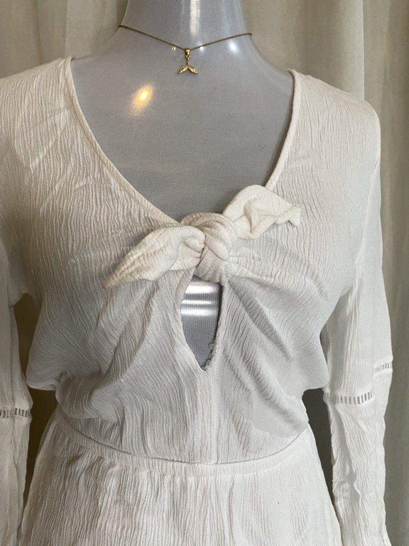 H&M White Textured V-Neck Tie Front Romper (Category: Rompers) located in Manila. Submitted by cami0110 (Listing ID 1443656447, Image 2). Description: - White textured romper from H&M - V-neck with a tie front detail - Long bell sleeves with stylish cut-out details - Comfortable elasticated waist - Ideal for beach days or casual outings -Visible stains at the back.