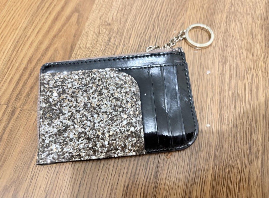Kate Spade Glitter Card Holder with Keychain (Category: Wallets & Card holders) located in Manila. Submitted by zoemycat (Listing ID 1443683917, Image 3). Description: - Sparkly Kate Spade card holder - Adorable clover detail on the front - Secure zip closure to keep cards safe - Convenient keychain ring included - Multiple card slots on the back for easy organization - Ideal for keeping your essentials tidy.