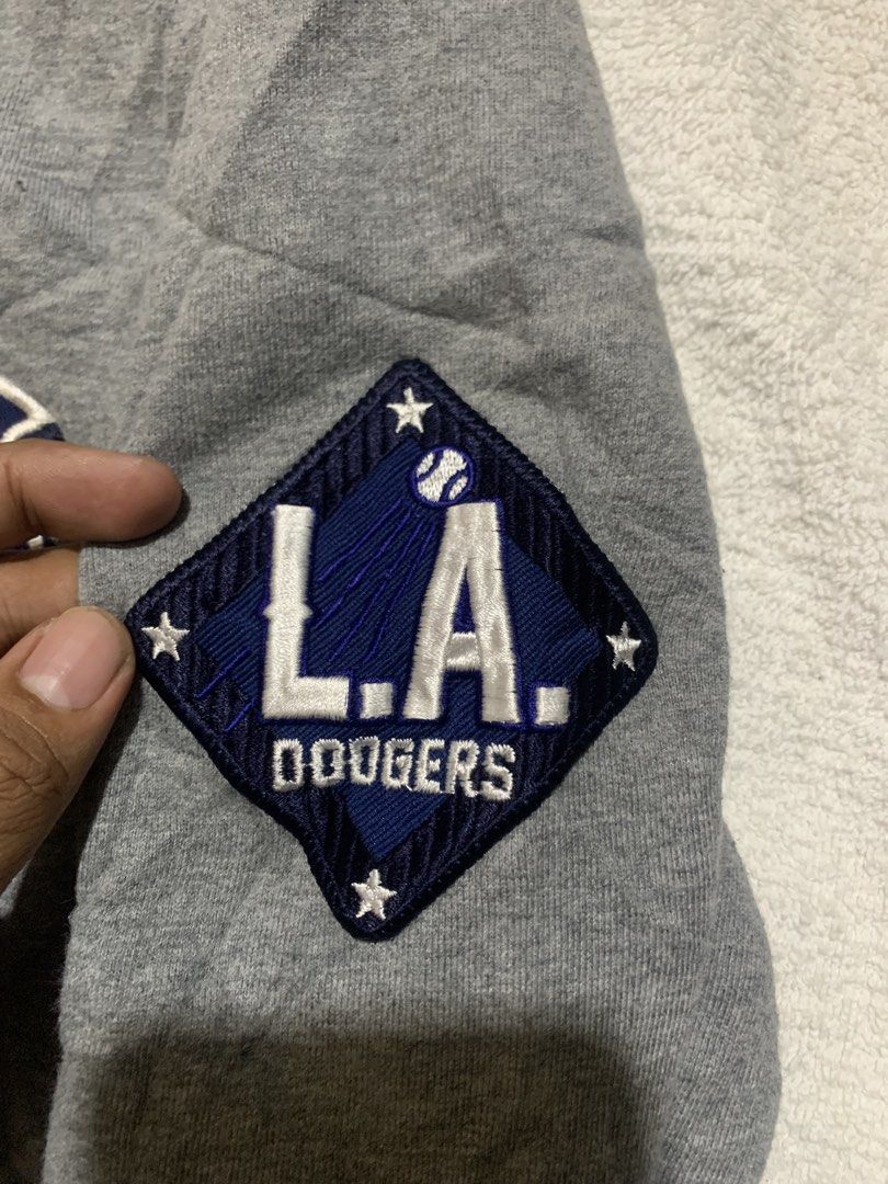 LA Dodgers MLB Grey Crewneck Sweatshirt (Category: Coats, Jackets and Outerwear) located in Iloilo. Submitted by johnpullan30303 (Listing ID 1443679179, Image 3). Description: - Grey LA Dodgers MLB crewneck sweatshirt - Iconic embroidered Dodgers logo on the chest - LA Dodgers team patch on the left sleeve - Comfortable crewneck design - MLB official tag visible inside - Perfect for Los Angeles Dodgers fans.