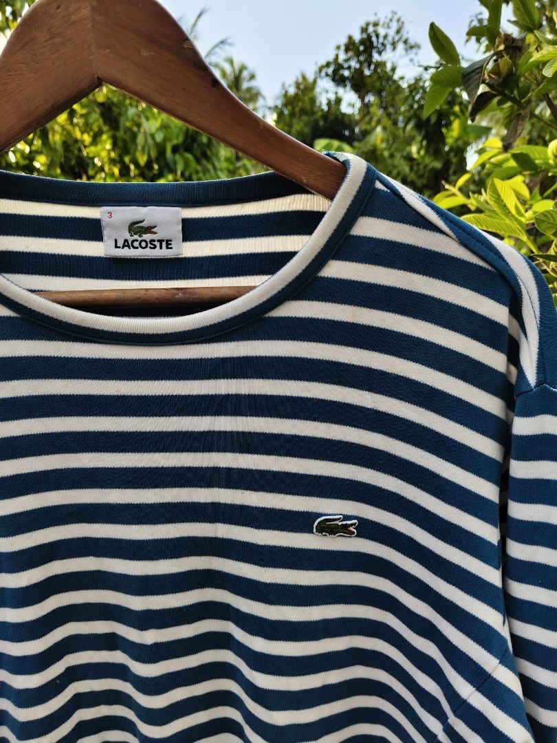 Lacoste Striped Long Sleeve Shirt (Category: Longsleeves) located in Manila. Submitted by de_uno1 (Listing ID 1443604556, Image 2). Description: - Classic blue and white striped long-sleeved shirt - Brand: Lacoste - Features iconic crocodile logo on chest - Comfortable and versatile for everyday wear - Great for layering or wearing on its own -Need wash.