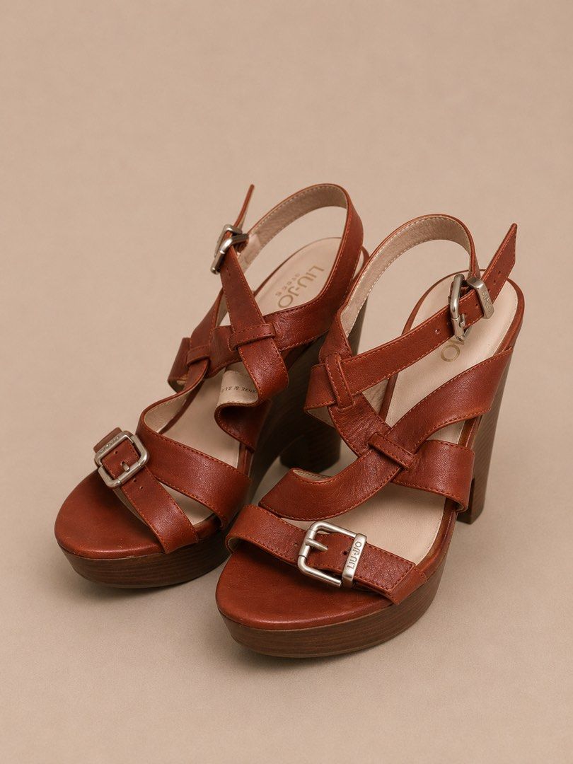 Liu Jo Brown Genuine Leather Platform Sandal size 38 (Category: Shoe inserts) located in Las Pinas. Submitted by abby_e_g (Listing ID 1443633034, Image 3). Description: Liu Jo wedge sandals feature a distinct crossover strap design and a metallic buckle closure Size 38 UK.