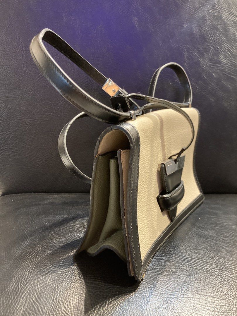 Loewe Barcelona (Category: Luxury Bags & Wallets) located in Quezon City. Submitted by janisu0303 (Listing ID 1443681945, Image 3). Description: - Loewe Barcelona Shoulder bag - Color: Beige and Black - 10,500 php - issue rubber piping lang - Material: Genuine Leather - Iconic Puzzle Design - Adjustable Strap - Ideal for Everyday Use Fairview area meetups Or shipping Loewe puzzle bag Gucci Prada Miu Miu Dior.