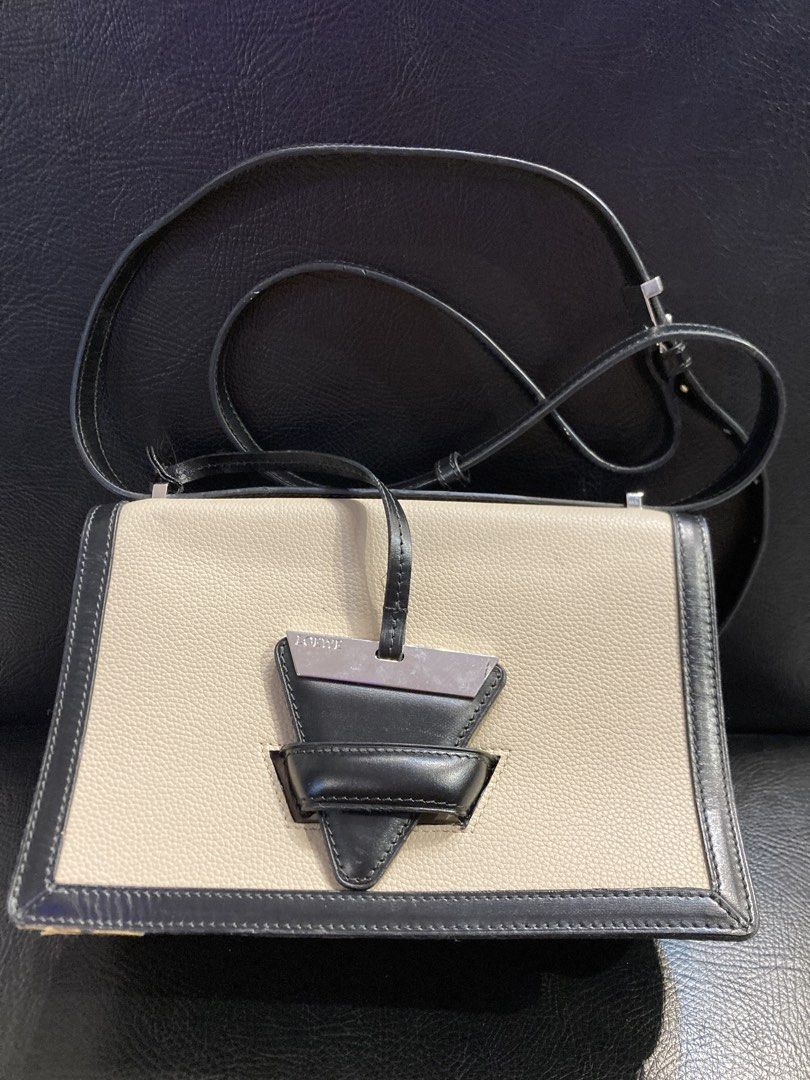 Loewe Barcelona (Category: Luxury Bags & Wallets) located in Quezon City. Submitted by janisu0303 (Listing ID 1443681945, Image 2). Description: - Loewe Barcelona Shoulder bag - Color: Beige and Black - 10,500 php - issue rubber piping lang - Material: Genuine Leather - Iconic Puzzle Design - Adjustable Strap - Ideal for Everyday Use Fairview area meetups Or shipping Loewe puzzle bag Gucci Prada Miu Miu Dior.