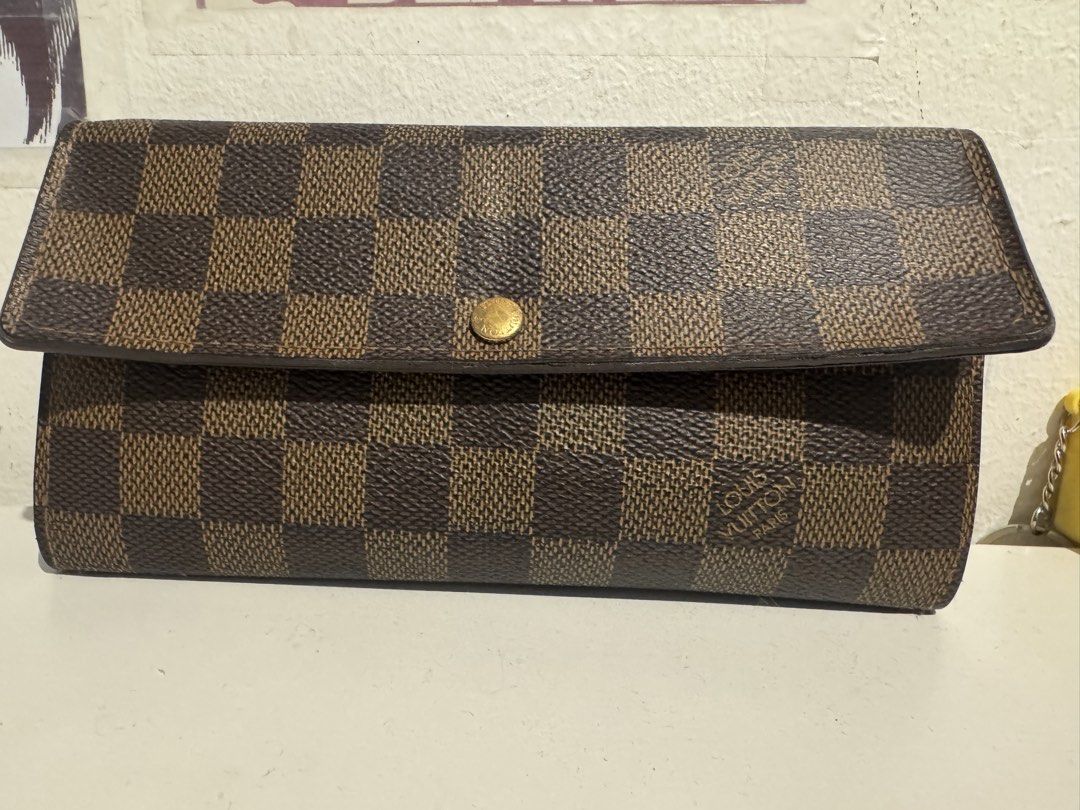 Louis Vuitton Damier Ebene Sarah Wallet (Category: Luxury Bags & Wallets) located in Pasig City. Submitted by acffashion31 (Listing ID 1443692591, Image 1). Description: - Authentic Louis Vuitton Sarah Wallet - Damier Ebene Canvas - Classic checkered pattern - Multiple card slots and compartments - Secure snap button closure - Ideal for everyday use - Flaws: Rubs inner part as seen in the last photo - Money back guaranteed.