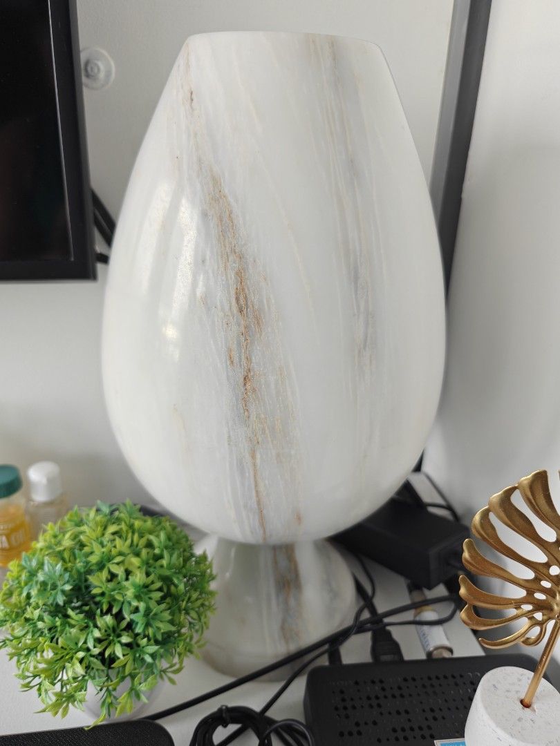 Solid Marble Table Lamp (Category: Lighting) located in Pasig City. Submitted by phonefanatic (Listing ID 1443528200, Image 1). Description: - Unique egg-shaped table lamp made from solid marble - Beautiful marble-like finish with white and beige swirls - Creates a soft, ambient glow - Ideal for bedside tables or living room accents - Very Heavy - Comes with a power cord.
