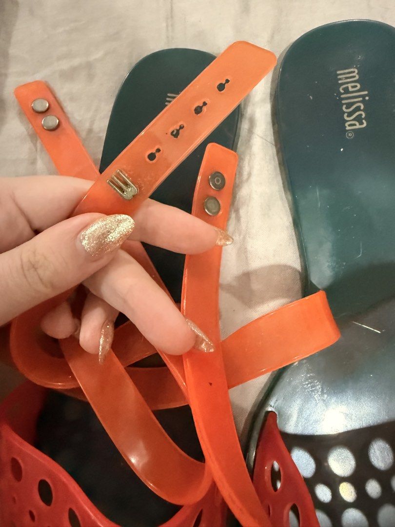 Melissa Orange & Teal Jelly Sandals (Category: Flats & Sandals) located in Paranaque City. Submitted by mrschuadeclutter (Listing ID 1443639464, Image 3). Description: - Melissa jelly sandals - Teal color with vibrant orange straps - Unique cut-out detail on straps - Secure ankle tie closure - Ideal for summer, beach days, or casual outings.