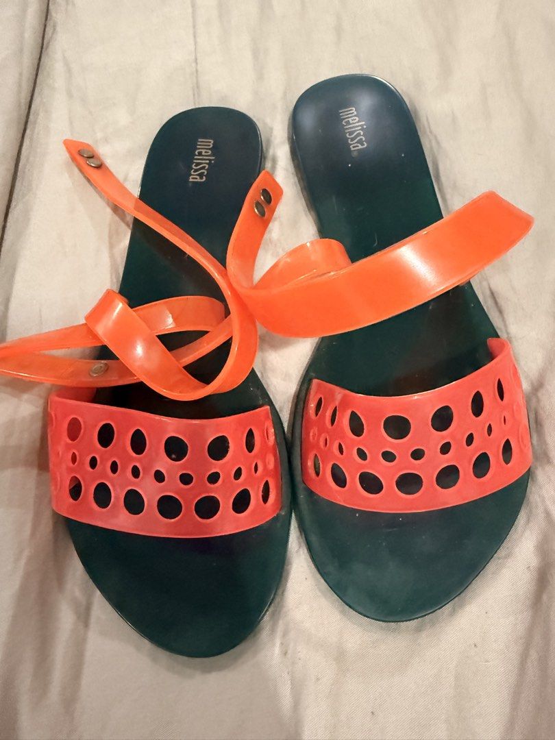 Melissa Orange & Teal Jelly Sandals (Category: Flats & Sandals) located in Paranaque City. Submitted by mrschuadeclutter (Listing ID 1443639464, Image 2). Description: - Melissa jelly sandals - Teal color with vibrant orange straps - Unique cut-out detail on straps - Secure ankle tie closure - Ideal for summer, beach days, or casual outings.