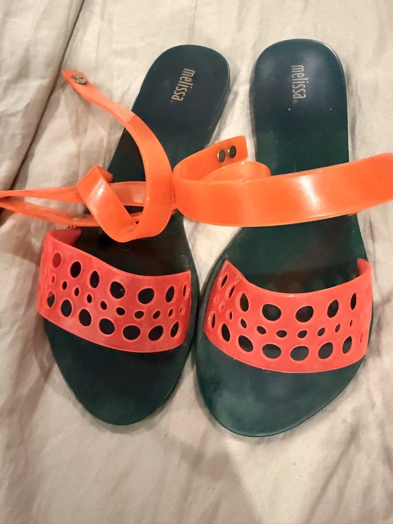 Melissa Orange & Teal Jelly Sandals (Category: Flats & Sandals) located in Paranaque City. Submitted by mrschuadeclutter (Listing ID 1443639464, Image 1). Description: - Melissa jelly sandals - Teal color with vibrant orange straps - Unique cut-out detail on straps - Secure ankle tie closure - Ideal for summer, beach days, or casual outings.
