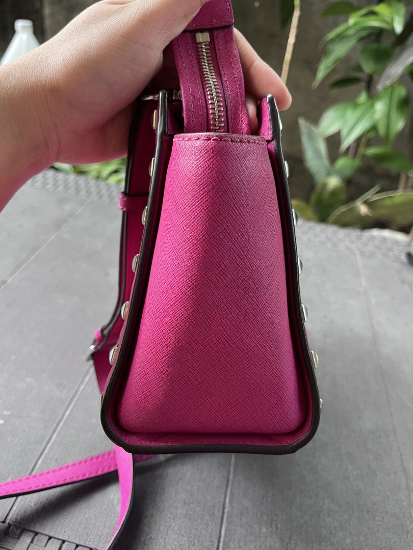 Michael Kors Pink Studded Crossbody Bag (Category: Cross-body Bags) located in Quezon City. Submitted by thriftfindsphqc (Listing ID 1443696409, Image 3). Description: - Authentic Pink Michael Kors Crossbody Bag - Stylish silver stud details on front and sides - Adjustable strap for comfortable wear - Secure zipper closure - Minor orange mark on bottom corner (visible in last photo).
