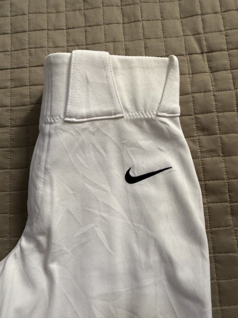 Nike White Baseball Pants "Team" L 26-28x34 (Category: Trousers) located in Cainta. Submitted by chagoods (Listing ID 1443629721, Image 2). Description: - White Nike Baseball Pants - Size: Large - Waist Fit: 26-28 inches - Inseam: 34 inches - Model: "Team" - Features: Elastic waistband, belt loops, zipper and button closure - Design: Black Nike swoosh logo on left leg - Ideal for: Baseball or softball.