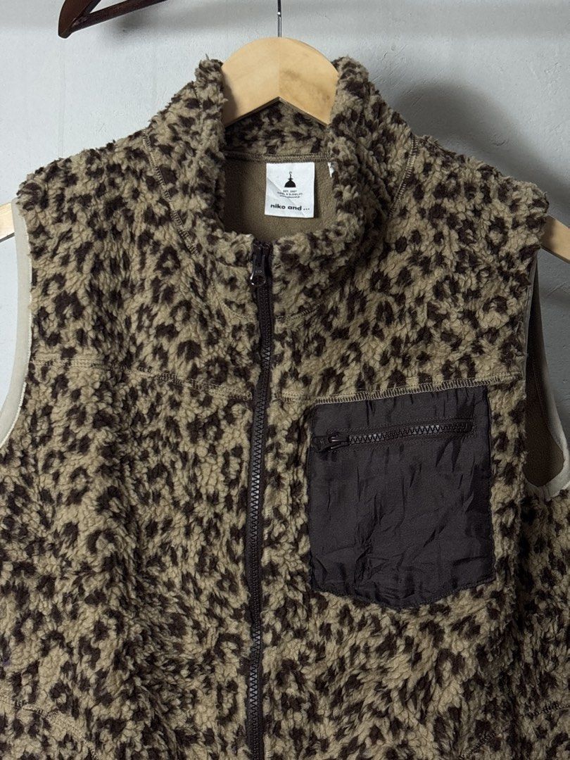 Niko and... Leopard Print Fleece Vest (Category: Vests) located in Manila. Submitted by angelll444 (Listing ID 1443655736, Image 2). Description: - 21x26 Medium - Super cozy leopard print fleece vest from Niko and... - Soft and fluffy material for ultimate comfort. - Features a zip-up front for easy wear. - Includes a chest pocket with a zip closure for secure storage. - Ideal for layering during cooler weather. - Effortlessly style for a casual 