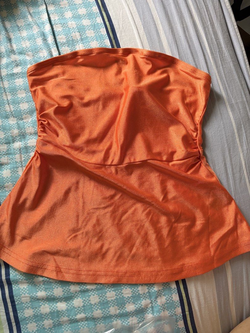 Orange Tube Top (Category: Others Tops) located in Pasig City. Submitted by declutter_dpc (Listing ID 1443617287, Image 2). Description: - Cute orange peplum tube top - Stretchy material for comfort - Ruched sides create a flattering silhouette - Versatile: great for night outs or casual days - Easy to style with jeans or skirts.