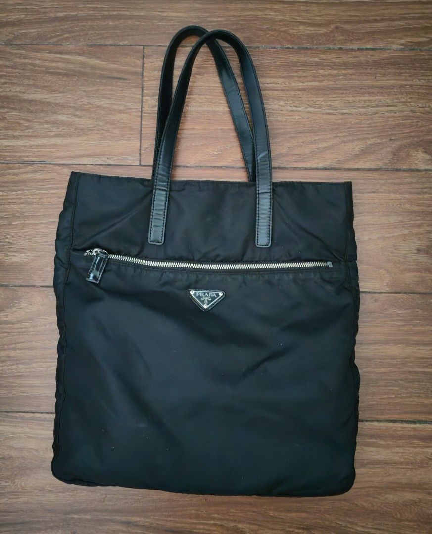 Prada Nylon Tote Bag (Category: Luxury Bags & Wallets) located in Davao. Submitted by athenaprelovedph (Listing ID 1443642461, Image 1). Description: - Prada tote bag in classic black. -no white tag - lightweight nylon material. -Large size - Convenient front zippered pocket. - Spacious interior for all your essentials. - Ideal for daily use and a timeless addition to your collection..