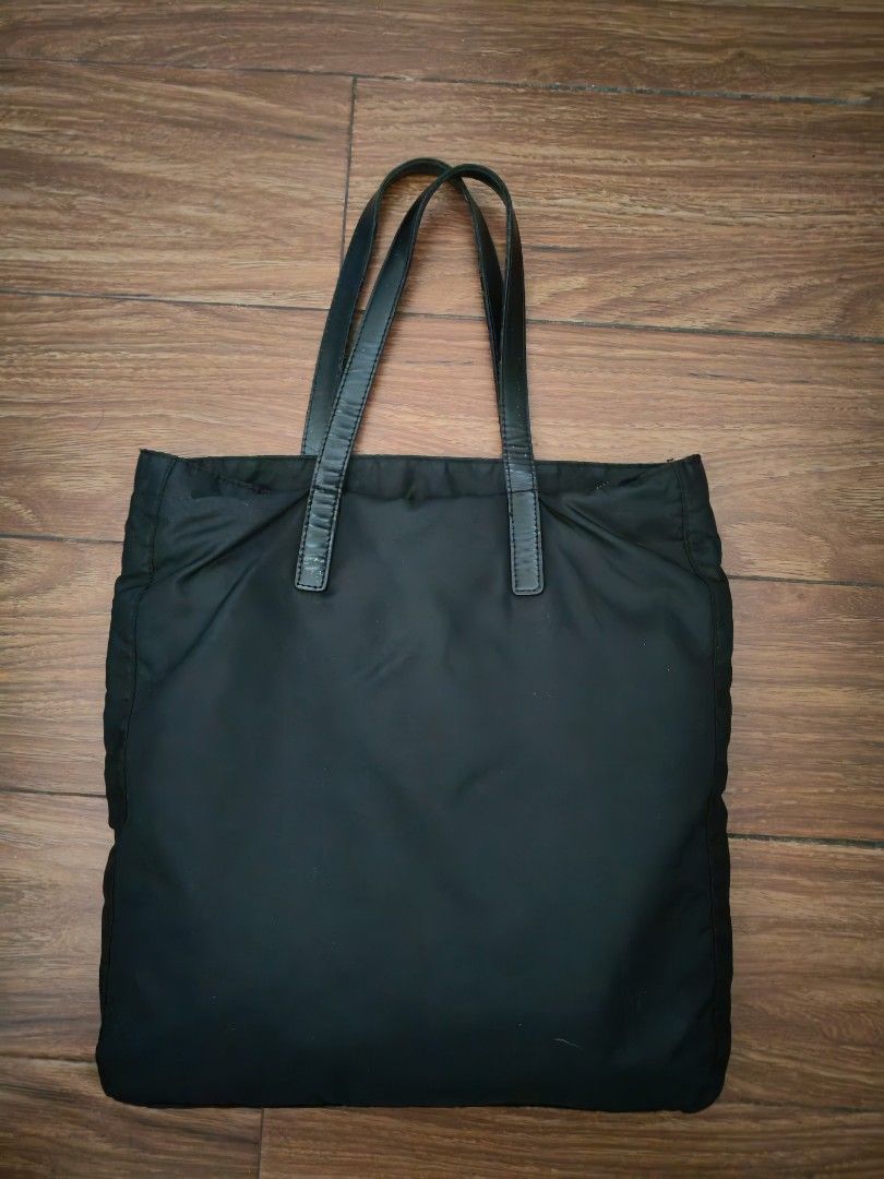 Prada Nylon Tote Bag (Category: Luxury Bags & Wallets) located in Davao. Submitted by athenaprelovedph (Listing ID 1443642461, Image 2). Description: - Prada tote bag in classic black. -no white tag - lightweight nylon material. -Large size - Convenient front zippered pocket. - Spacious interior for all your essentials. - Ideal for daily use and a timeless addition to your collection..