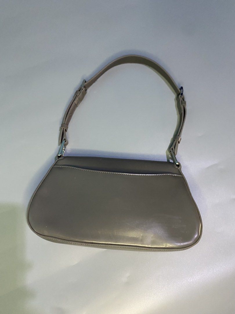 Prada Re-Edition 2000 Nylon Bag Taupe (Category: Luxury Bags & Wallets) located in Cebu City. Submitted by nardcen (Listing ID 1443571787, Image 2). Description: - Authentic Prada bag - Color: Taupe - Finish: Shiny - Iconic Prada triangle logo on front - Adjustable strap with silver hardware - Small and chic, ideal for essentials - Minimal signs of wear - Comes with original dustbag.