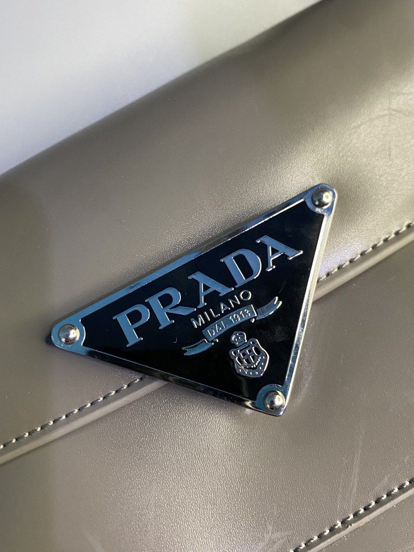 Prada Re-Edition 2000 Nylon Bag Taupe (Category: Luxury Bags & Wallets) located in Cebu City. Submitted by nardcen (Listing ID 1443571787, Image 3). Description: - Authentic Prada bag - Color: Taupe - Finish: Shiny - Iconic Prada triangle logo on front - Adjustable strap with silver hardware - Small and chic, ideal for essentials - Minimal signs of wear - Comes with original dustbag.